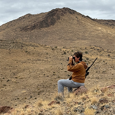 youth glassing with a rifle on a cloudy day